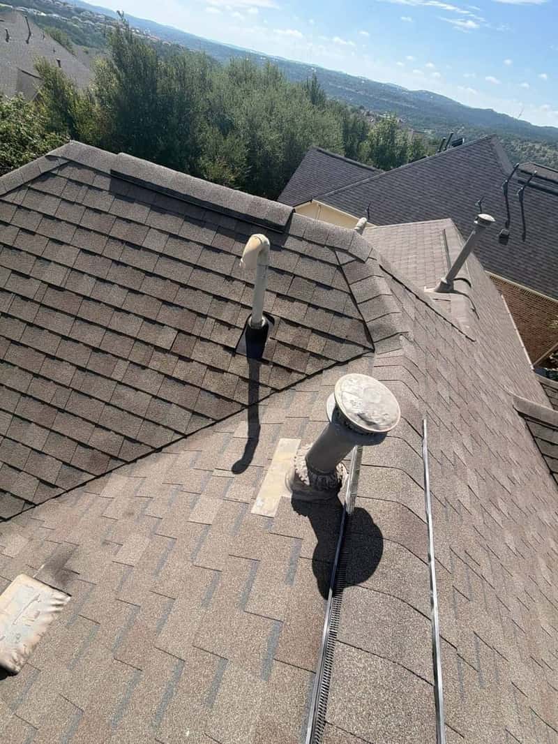 Roof ridge and vent stack with a sweeping Texas Hill Country view in the background